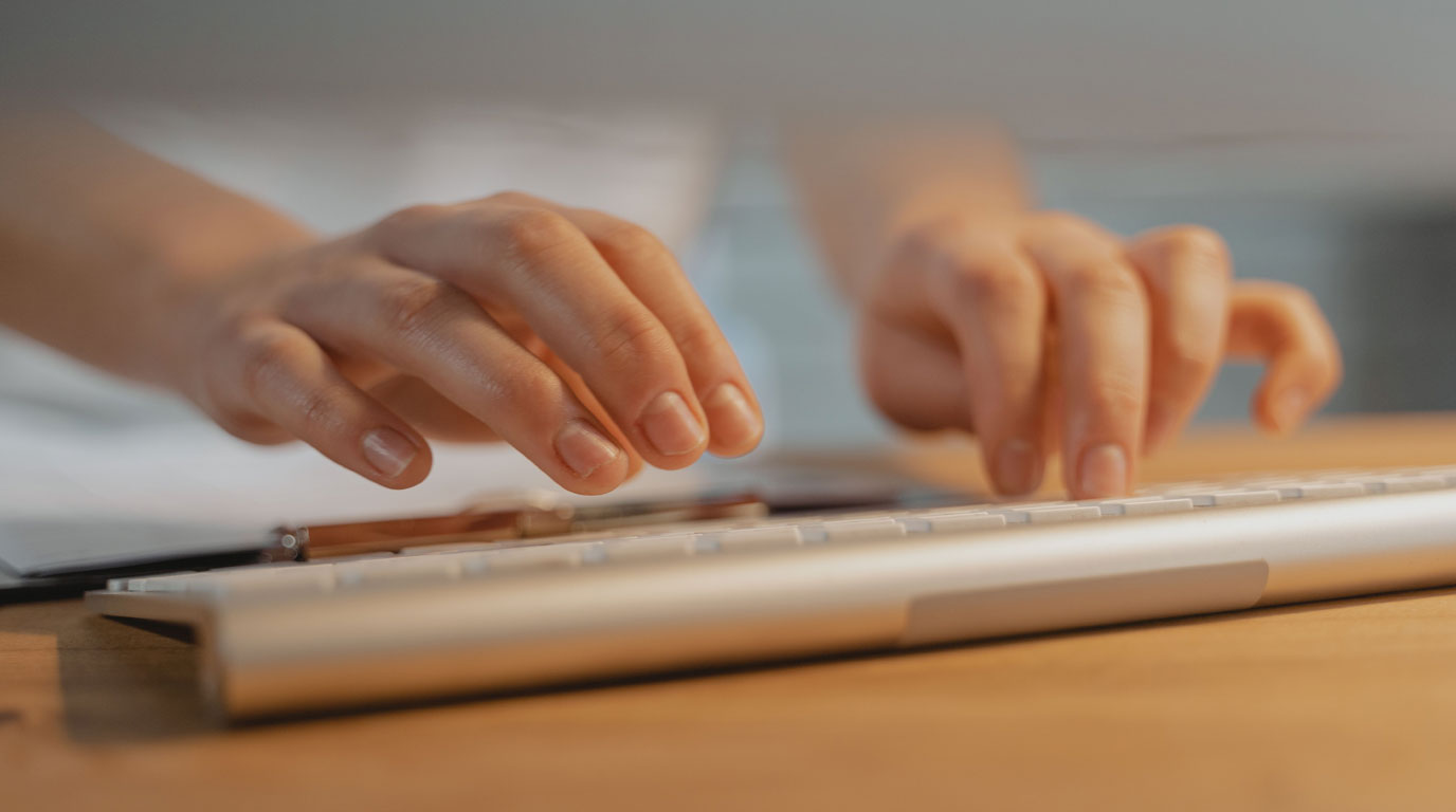 A colorado provider enters patient data at a keyboard.